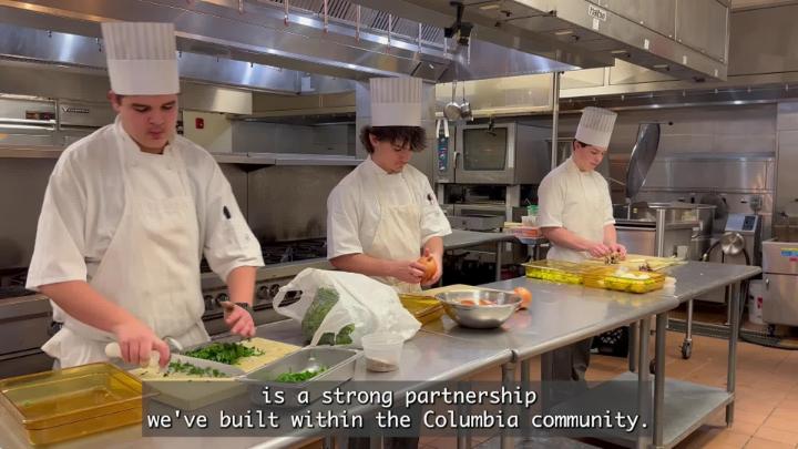 Three Culinary Arts students working in their kitchen